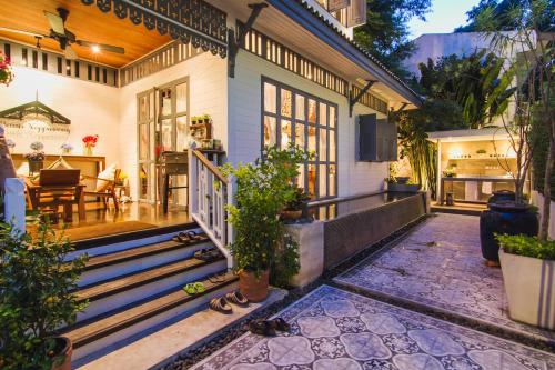 an exterior view of a house with a porch at Baan Noppawong in Bangkok