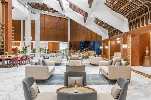 a lobby of a hotel with chairs and tables at Makarem Ajyad Makkah Hotel in Makkah