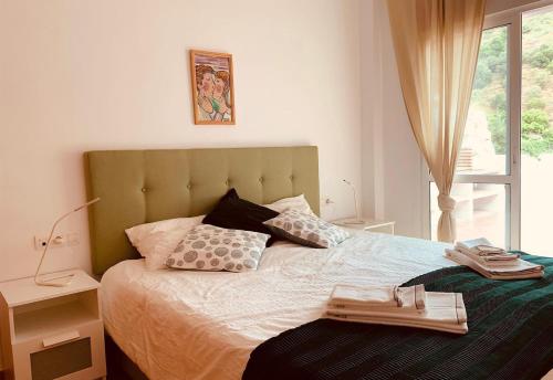 a bedroom with a large bed with a window at Casa Verdejo in Cómpeta