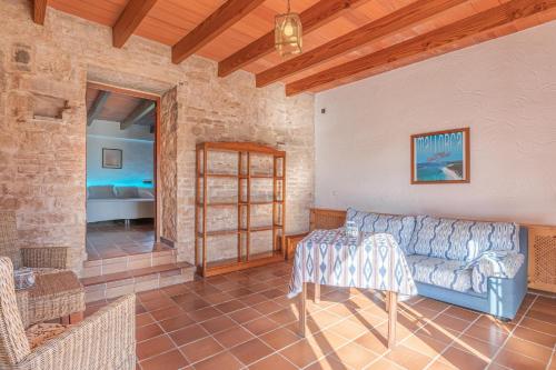 a living room with a couch and a table at Es turo de Menorca in Ses Salines