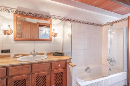 a bathroom with a sink and a shower and a tub at Es turo de Menorca in Ses Salines