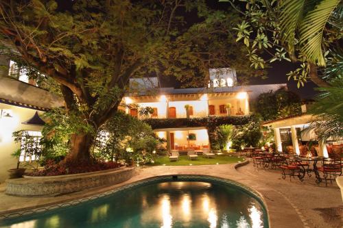 a pool in front of a house at night at Hotel Boutique La Casa Azul in Cuernavaca