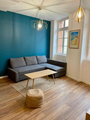 a living room with a couch and a coffee table at République - Grande la Réal in Perpignan