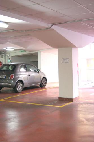 a small car parked in a parking garage at The Jasmine Terrace Retreat in Bologna