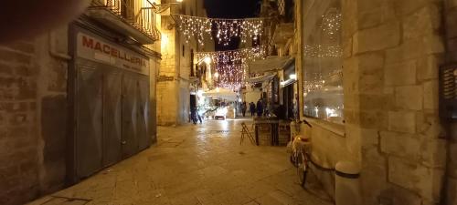 an empty street with christmas lights in an alley at Awesomehouse centre Bari in Bari