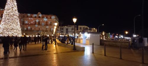 a group of people walking down a street with a christmas tree at Awesomehouse centre Bari in Bari