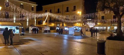 a group of people standing in a courtyard with lights at Awesomehouse centre Bari in Bari