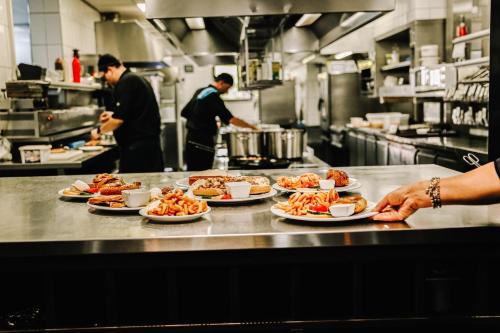 a group of people in a kitchen with plates of food at Hotel Frans op den Bult in Deurningen