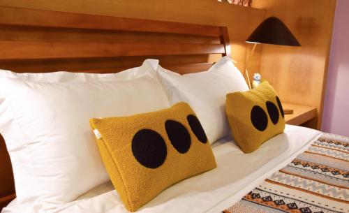 a bed with two panda pillows on it at South Island 206 in Hengchun