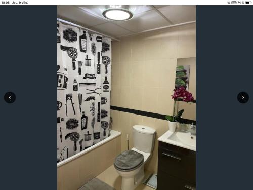 a bathroom with a toilet and a shower curtain at Appartement Golf PANORAMICA in Sant Jordi
