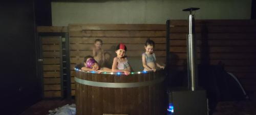a group of children sitting in a hot tub at Beskidzki Klimat Jaśliska in Jaśliska