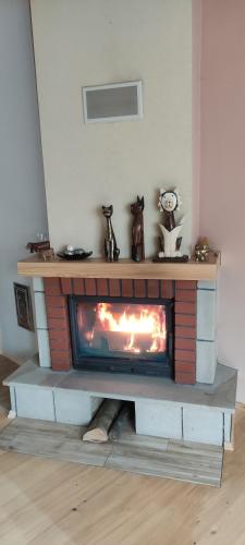 a fireplace in the corner of a living room at Beskidzki Klimat Jaśliska in Jaśliska