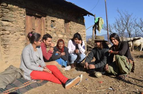 a group of people sitting in front of a building at Dhanaulti Camp Homes Retreat in Dhanaulti