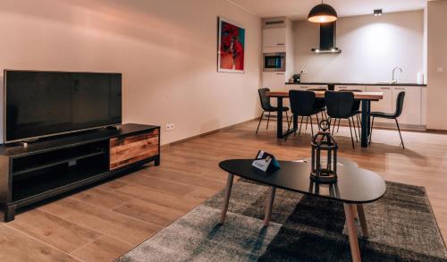 Una televisión o centro de entretenimiento en Appartementen by WP Hotels