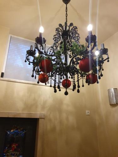 a chandelier hanging from a ceiling with a window at R & R Apartments in Sofia