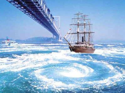 a boat in the water next to a bridge at Awaji Large Log house in Goshiki 2 in Sumoto
