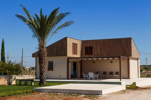 a house with a palm tree in front of it at B&B Giardinello in Comiso