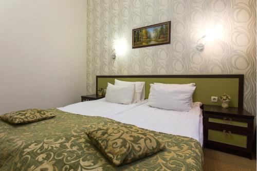 a hotel room with two beds with white pillows at Hotel Voyage in Kharkiv