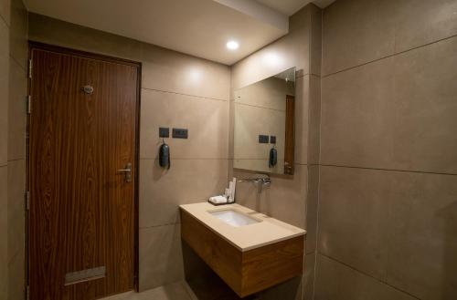 a bathroom with a sink and a mirror at Surya Heritage Hotels in Kannur