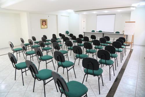 a room with green and black chairs in a classroom at Big Executive Hotel in Araguari