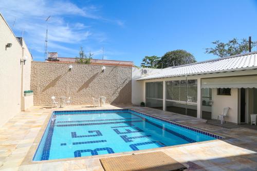 a swimming pool in the backyard of a house at Big Executive Hotel in Araguari