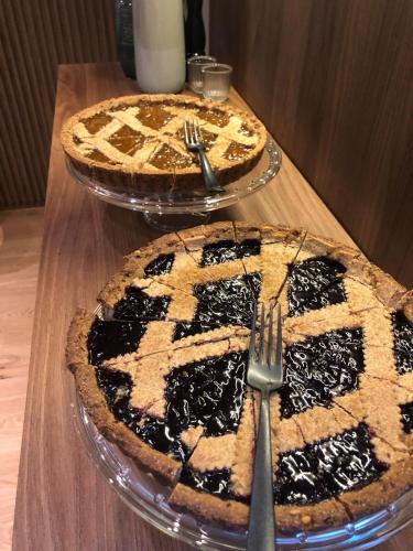 two pies sitting on top of a wooden table at ELICAL Exclusive Private Suites in Rome