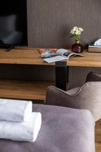 a desk with a television and a table with chairs at Loft7 in Lviv