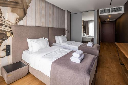 a bedroom with two beds with white towels on them at Loft7 in Lviv