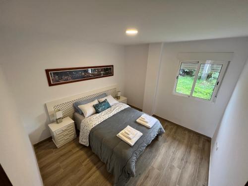 a bedroom with a bed and a window at Parque La Guina in La Orotava