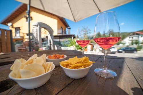 a wooden table with chips and a glass of wine at Albergo Ad Astra in Pescasseroli