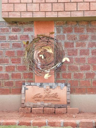 a bird nest on the side of a brick wall at Mastiff Grand La Villae in Lonavala
