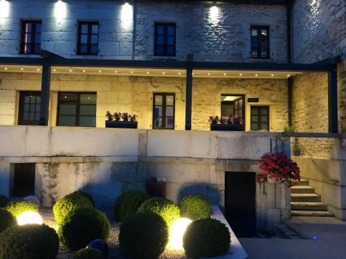 a building with a bunch of plants and lights at Logis L'Hôtel D'Arc in Arc-sur-Tille