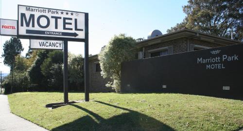 a sign that is on the side of a road at Marriott Park Motel in Nowra