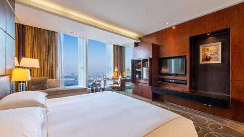a hotel room with a large bed and a tv at InterContinental Nanjing by IHG in Nanjing