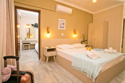 a hotel room with a bed and a bathroom at Kalypso Studios in Myrties