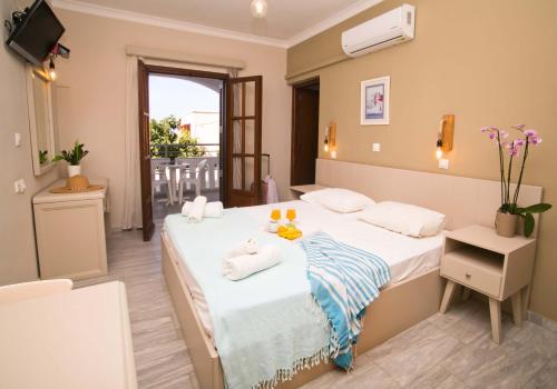 a bedroom with a bed with towels on it at Kalypso Studios in Myrties