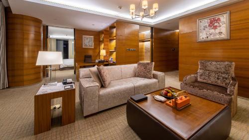 a living room with a couch and a chair at InterContinental Nanjing, an IHG Hotel in Nanjing