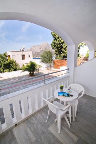 a balcony with a table and chairs and a view at Kalypso Studios in Myrties