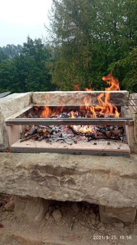 a fire is burning in a stone oven at Cascina Boschetto in Saliceto
