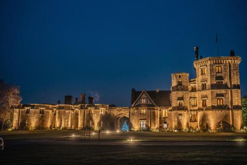 an old building with a christmas tree in front of it at Thornbury Castle - A Relais & Chateaux Hotel in Thornbury