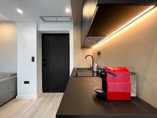 a red suitcase sitting on a counter in a kitchen at ICON Urban Living in Thessaloniki