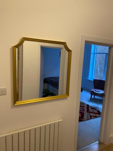 a mirror on a wall in a room at Spacious 2 Bedroom Apartment in Woolwich Arsenal in Woolwich
