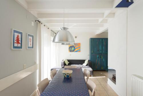 een eetkamer met een tafel en een bank bij Kustverhuur, Park Schoneveld, Zeester 27 in Breskens