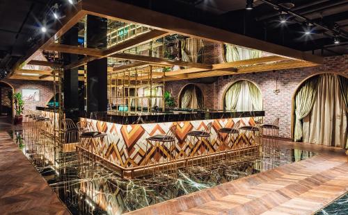 a bar with leather chairs in a room with a brick wall at Hyatt Regency Dubai Creek Heights in Dubai