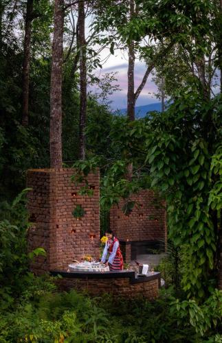 a person sitting at a table in a brick wall at Vivanta Sikkim Pakyong in Gangtok