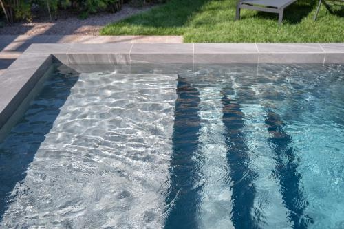 a pool of water with a bench sitting next to it at Relais Villa Borghetto in Valeggio sul Mincio