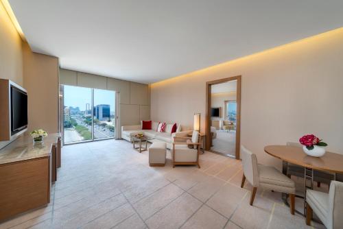 a living room with a couch and a table at Hyatt Regency Dubai Creek Heights in Dubai