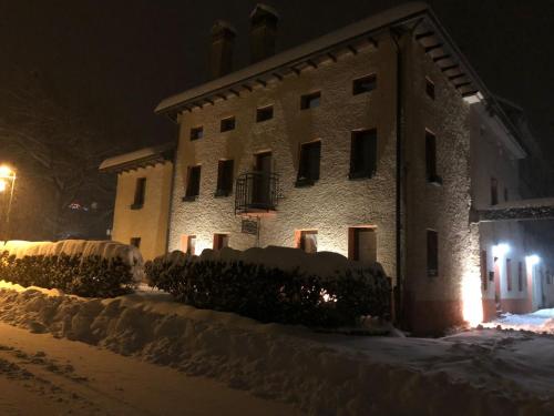 a building with snow in front of it at night at Antica Villa Sophie in Tortal