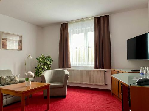 a living room with a room with a radiator and a window at gut-Hotel Pommernhotel Barth in Barth