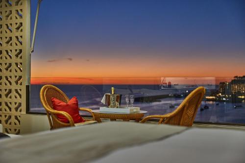 a room with a table and chairs and a large window at Doñana 1109 in Patalavaca